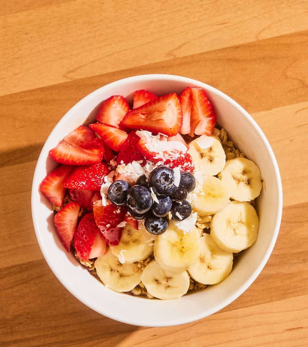 Açaí bowl from above with strawberries, blueberries, banana and granola