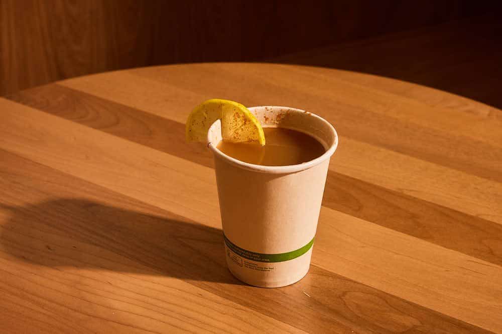 Cup of bone broth with a lemon slice