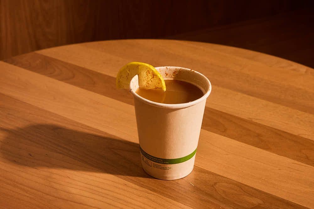 Cup of bone broth with a lemon slice