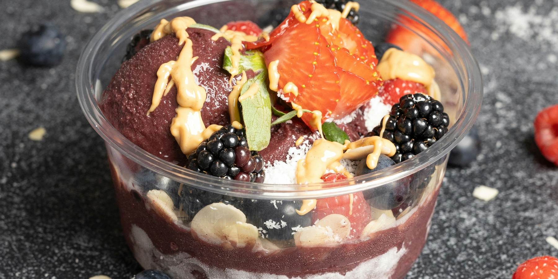 Açaí cup with berries, coconut and nut butter